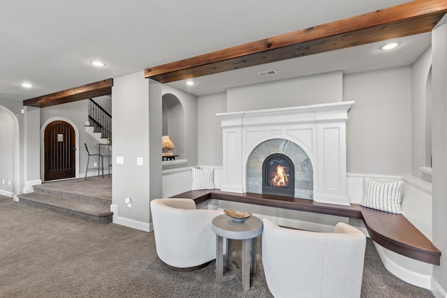 425 Carpenters Pt, Wayzata, MN 55391 - carpeted living room featuring arched walkways, beam ceiling, stairway, a lit fireplace, and recessed lighting