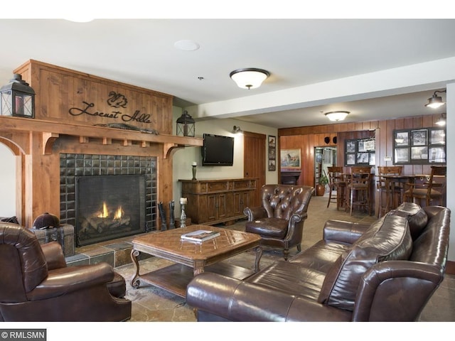 425 Carpenters Pt, Wayzata, MN 55391 - living area with a tile fireplace, wooden walls, and beam ceiling