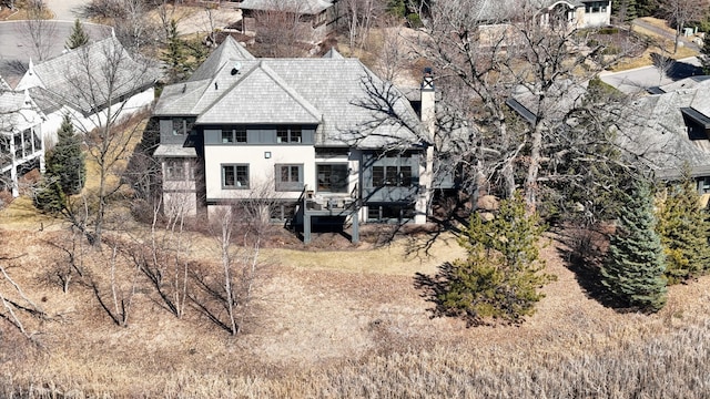 425 Carpenters Pt, Wayzata, MN 55391 - rear view of house with a chimney and stucco siding