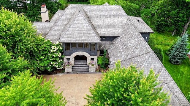 425 Carpenters Pt, Wayzata, MN 55391 - view of front of house featuring a chimney, stone siding, and stairway
