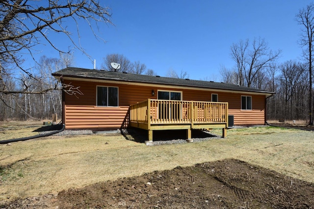 14113 260th St, Dailey Twp, MN 56353 - back of property featuring log veneer siding, a wooden deck, and a yard