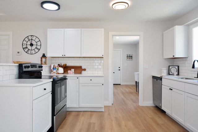 14113 260th St, Dailey Twp, MN 56353 - kitchen with stainless steel appliances, a sink, backsplash, and light countertops