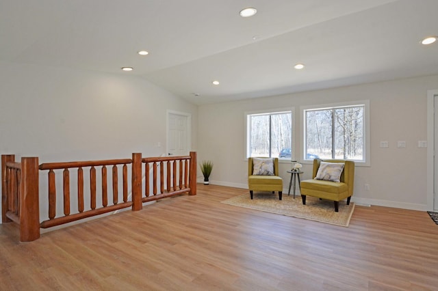 14113 260th St, Dailey Twp, MN 56353 - sitting room with an upstairs landing, light wood finished floors, recessed lighting, baseboards, and vaulted ceiling