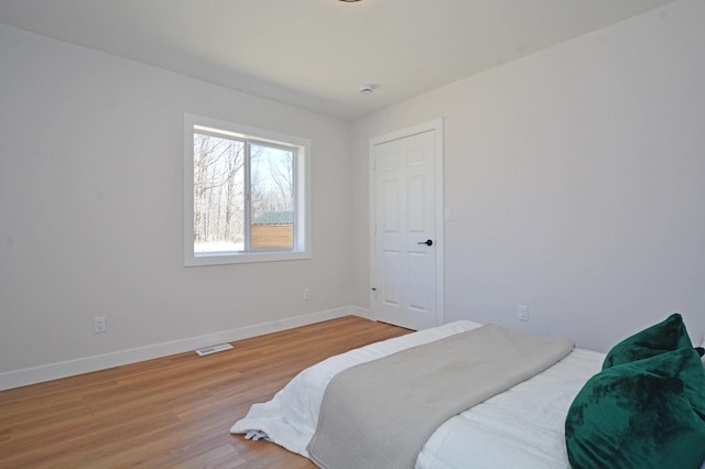 14113 260th St, Dailey Twp, MN 56353 - bedroom featuring baseboards and light wood-style floors