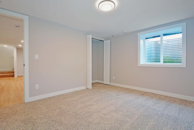 14113 260th St, Dailey Twp, MN 56353 - unfurnished bedroom with light carpet, a closet, and baseboards