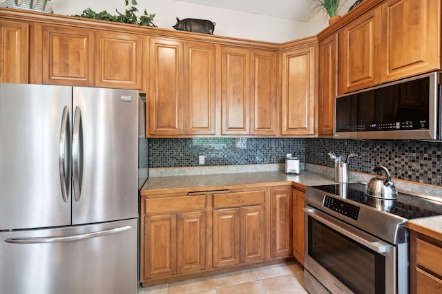4562 Hummingbird Trl NE, Prior Lake, MN 55372 - kitchen featuring stainless steel appliances, brown cabinets, tasteful backsplash, and light countertops