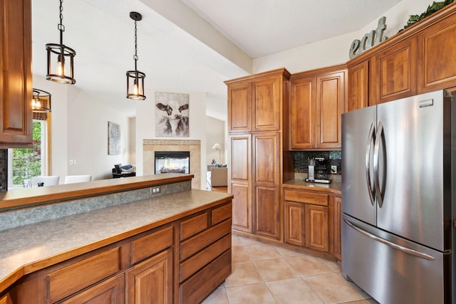 4562 Hummingbird Trl NE, Prior Lake, MN 55372 - kitchen with freestanding refrigerator, brown cabinets, backsplash, and decorative light fixtures