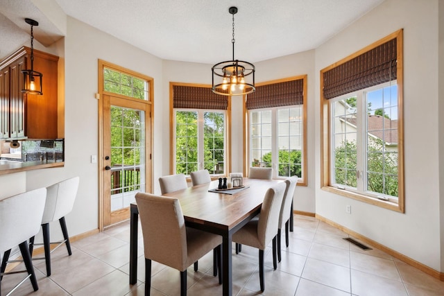 4562 Hummingbird Trl NE, Prior Lake, MN 55372 - dining space with a chandelier, baseboards, and light tile patterned floors