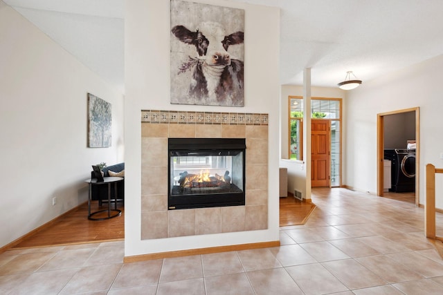 4562 Hummingbird Trl NE, Prior Lake, MN 55372 - tiled living area featuring independent washer and dryer, a fireplace, and baseboards
