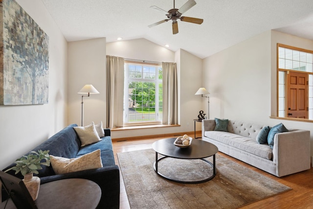 4562 Hummingbird Trl NE, Prior Lake, MN 55372 - living area featuring wood finished floors, vaulted ceiling, a ceiling fan, and a textured ceiling
