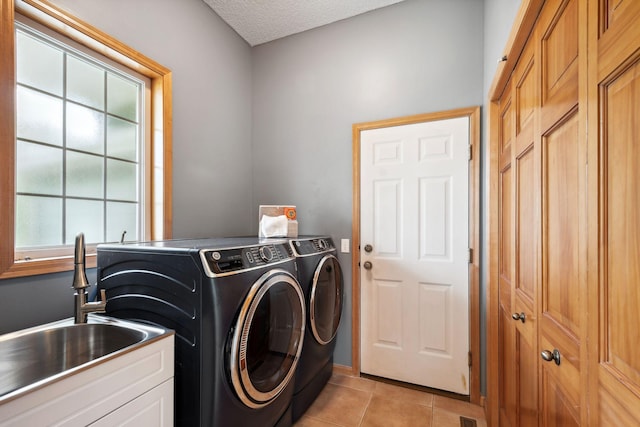 4562 Hummingbird Trl NE, Prior Lake, MN 55372 - laundry room with washer and dryer, healthy amount of natural light, light tile patterned floors, and a textured ceiling