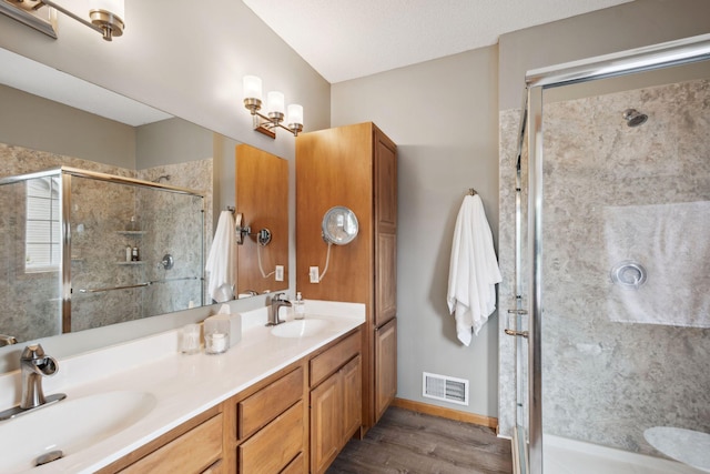 4562 Hummingbird Trl NE, Prior Lake, MN 55372 - bathroom featuring double vanity, a stall shower, wood finished floors, and baseboards