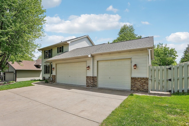 8671 Pheasant Run Rd, Woodbury, MN 55125 - traditional-style house with concrete driveway, a garage, brick siding, and a gate