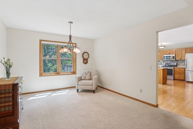 8671 Pheasant Run Rd, Woodbury, MN 55125 - sitting room featuring light carpet, baseboards, and a chandelier