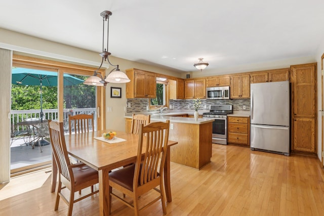 8671 Pheasant Run Rd, Woodbury, MN 55125 - dining area featuring light wood-style flooring and healthy amount of natural light