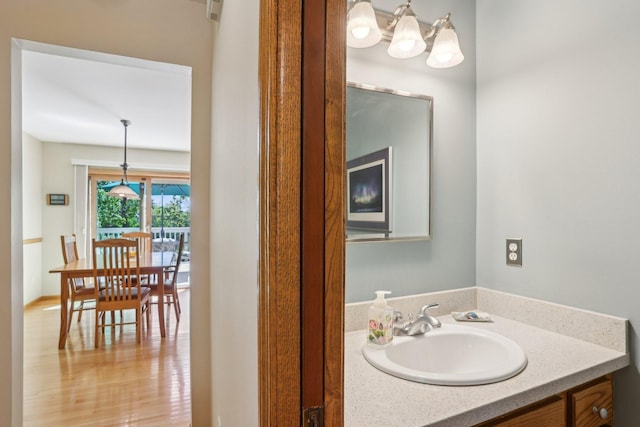 8671 Pheasant Run Rd, Woodbury, MN 55125 - bathroom with vanity and a chandelier