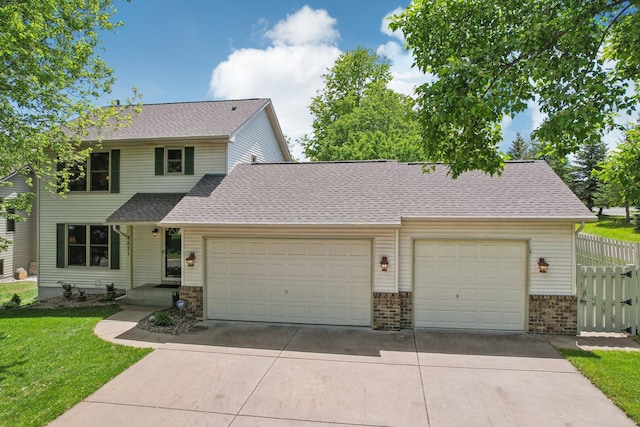 8671 Pheasant Run Rd, Woodbury, MN 55125 - traditional-style house featuring a garage, brick siding, concrete driveway, and roof with shingles