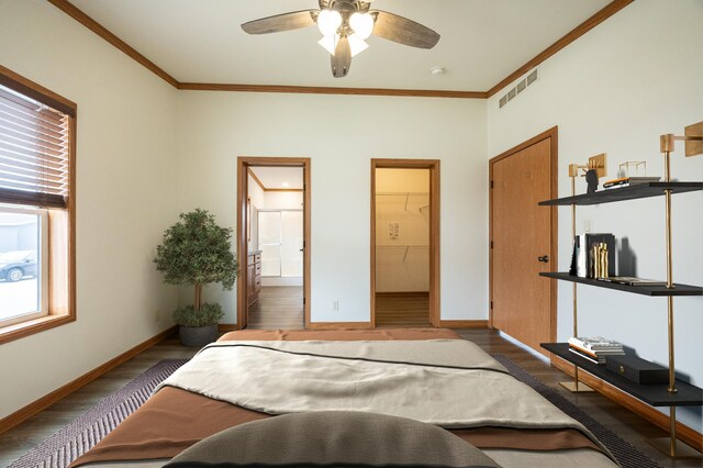 bedroom featuring crown molding, wood finished floors, and multiple windows
