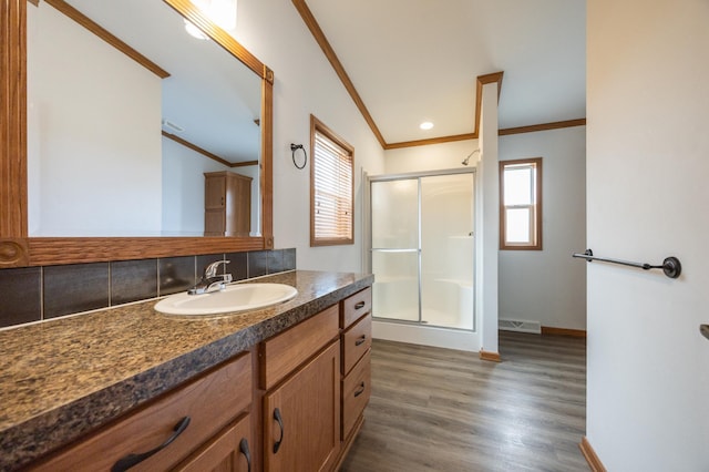 bathroom with visible vents, ornamental molding, a stall shower, and wood finished floors