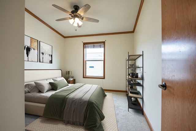 bedroom featuring light carpet, baseboards, crown molding, and a ceiling fan