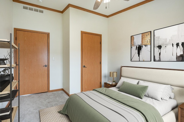 bedroom with baseboards, crown molding, a ceiling fan, carpet floors, and visible vents