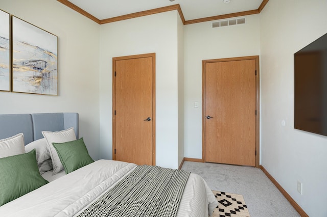 bedroom featuring crown molding, visible vents, baseboards, and carpet