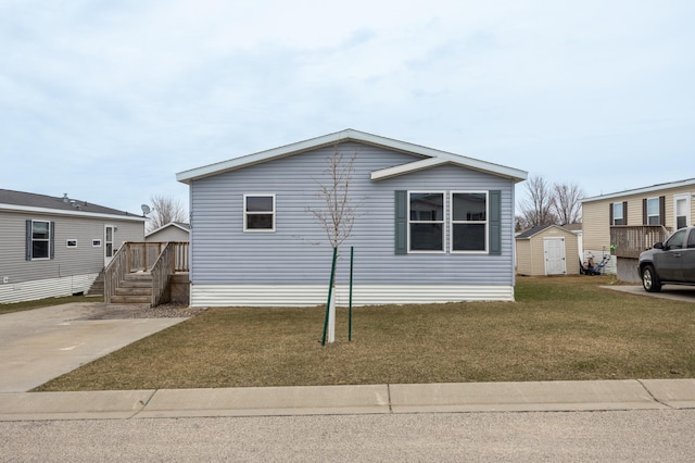view of front of home with an outbuilding, a storage unit, and a front lawn