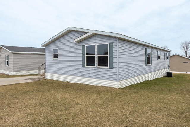 view of home's exterior featuring a yard and central AC unit