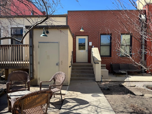 back of property featuring stucco siding, an outdoor hangout area, and a patio