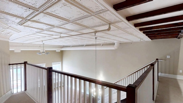 hallway with baseboards and an upstairs landing
