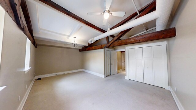 below grade area featuring carpet floors, visible vents, a ceiling fan, and baseboards