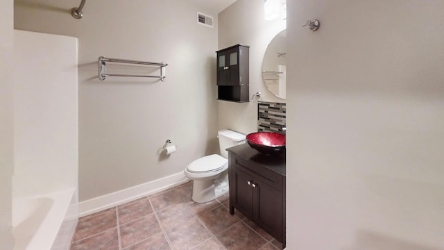bathroom with tile patterned floors, visible vents, toilet, a bath, and baseboards