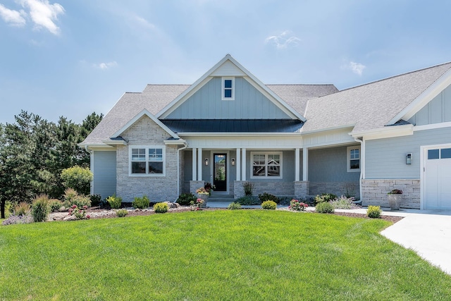 1005 Applewood Ct, Mankato, MN 56001 - craftsman-style house featuring stone siding, an attached garage, a front yard, board and batten siding, and roof with shingles