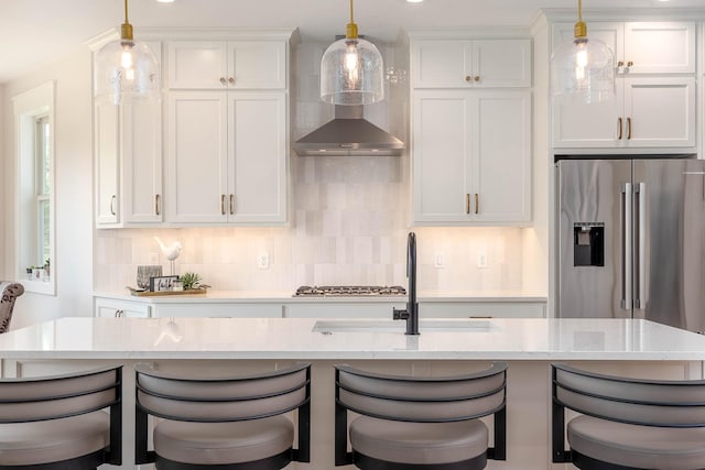 1005 Applewood Ct, Mankato, MN 56001 - kitchen with decorative backsplash, white cabinets, a breakfast bar, stainless steel appliances, and decorative light fixtures