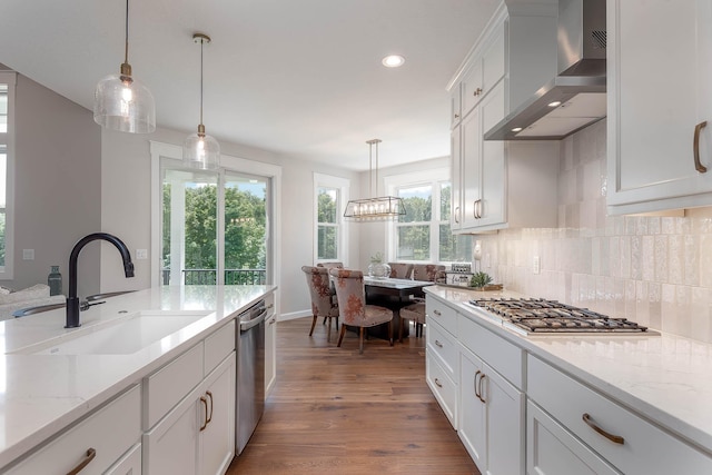 1005 Applewood Ct, Mankato, MN 56001 - kitchen featuring decorative backsplash, wood finished floors, wall chimney exhaust hood, stainless steel appliances, and a sink