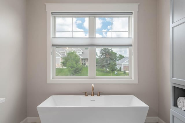 1005 Applewood Ct, Mankato, MN 56001 - bathroom with a freestanding bath, a sink, and baseboards