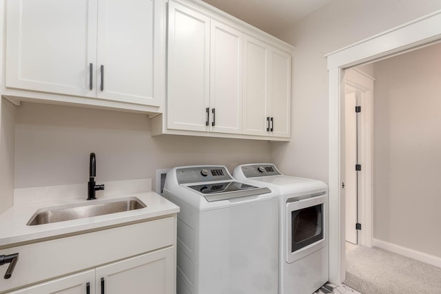 1005 Applewood Ct, Mankato, MN 56001 - clothes washing area with washing machine and clothes dryer, baseboards, light carpet, a sink, and cabinet space