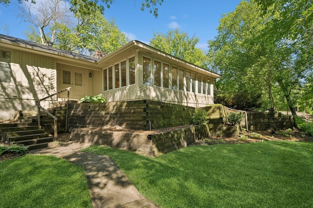 13907 Mcginty Rd E, Minnetonka, MN 55305 - view of property exterior featuring a sunroom and a lawn