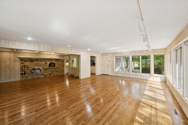 13907 Mcginty Rd E, Minnetonka, MN 55305 - unfurnished living room featuring light wood-style flooring, a brick fireplace, recessed lighting, and track lighting