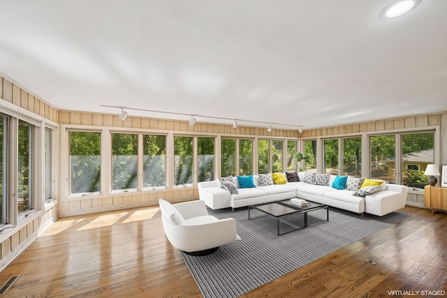 13907 Mcginty Rd E, Minnetonka, MN 55305 - sunroom / solarium featuring rail lighting, a deck, and wood finished floors
