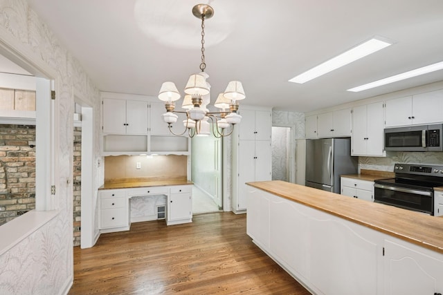 13907 Mcginty Rd E, Minnetonka, MN 55305 - kitchen featuring appliances with stainless steel finishes, open shelves, wood counters, white cabinets, and a chandelier