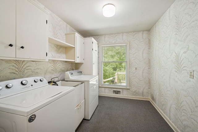 13907 Mcginty Rd E, Minnetonka, MN 55305 - laundry area with wallpapered walls, cabinet space, washer and dryer, dark carpet, and baseboards