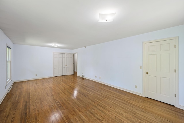 13907 Mcginty Rd E, Minnetonka, MN 55305 - empty room with wood finished floors and baseboards