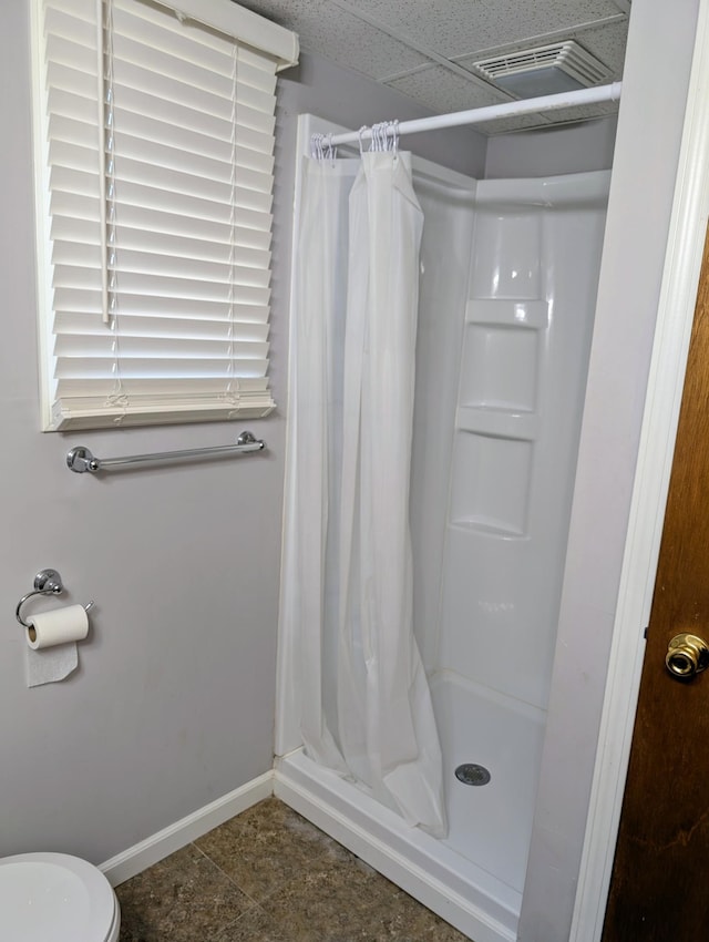 full bath featuring baseboards and a stall shower