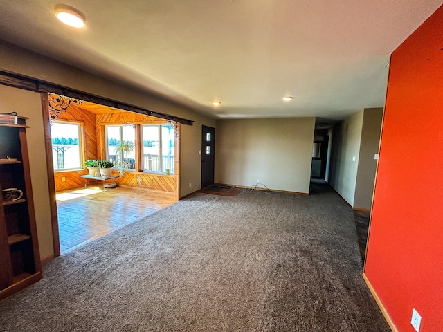carpeted empty room featuring recessed lighting and baseboards