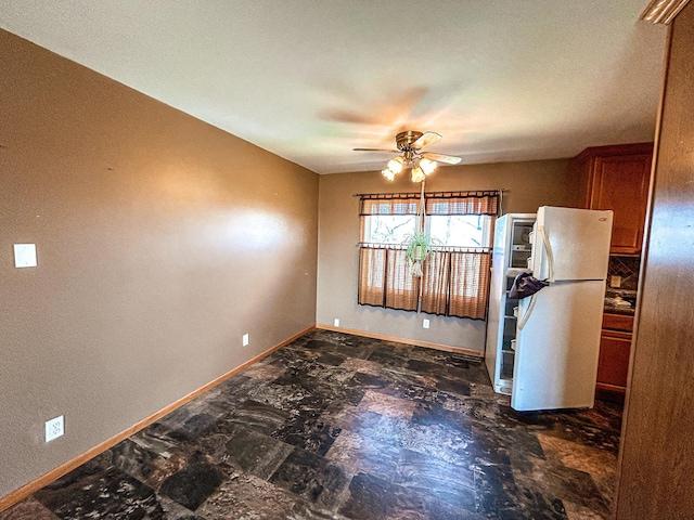 unfurnished room featuring baseboards and a ceiling fan