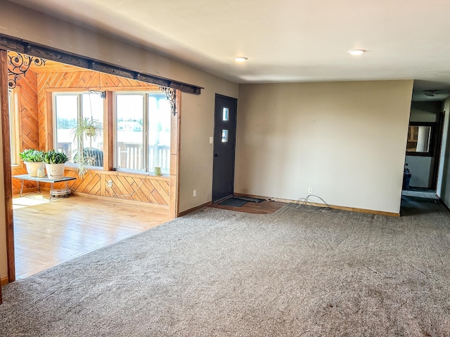 foyer entrance featuring recessed lighting, carpet flooring, and baseboards