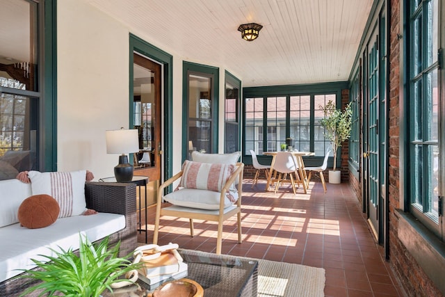 sunroom / solarium with wood ceiling and tile patterned flooring
