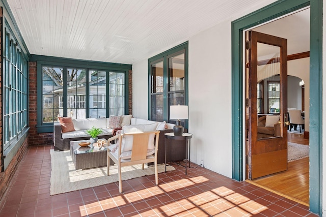 sunroom with arched walkways and plenty of natural light