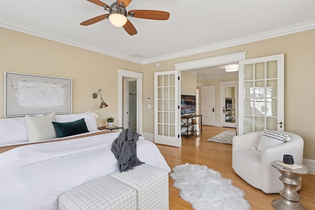 bedroom with ornamental molding, a ceiling fan, light wood-style floors, and french doors